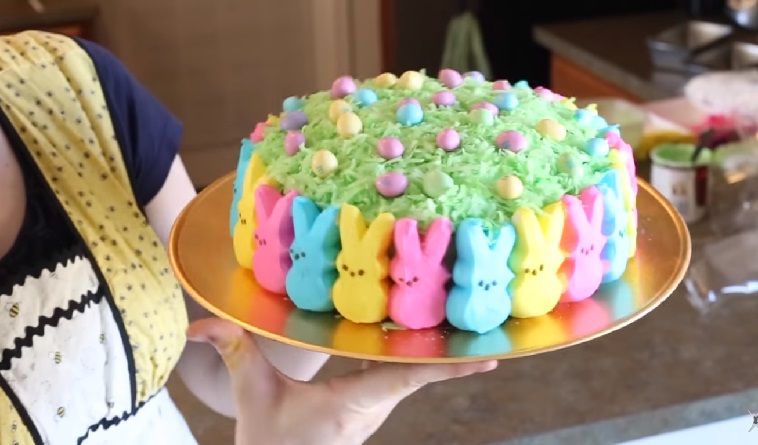 One of the prettiest Easter cakes is this one with multi-colored peeps around the sides, green coconut on top and candy eggs on the coconut.