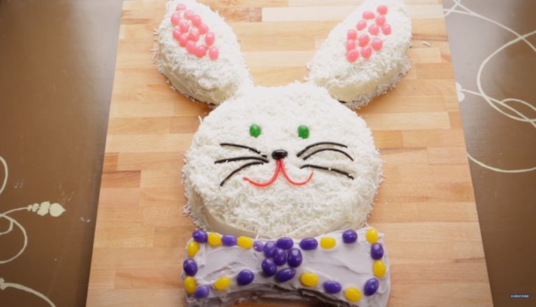 Easter cakes are often shaped like bunnies and this one is no different. Photo is a bunny cake with a bow tie decorates with candy.