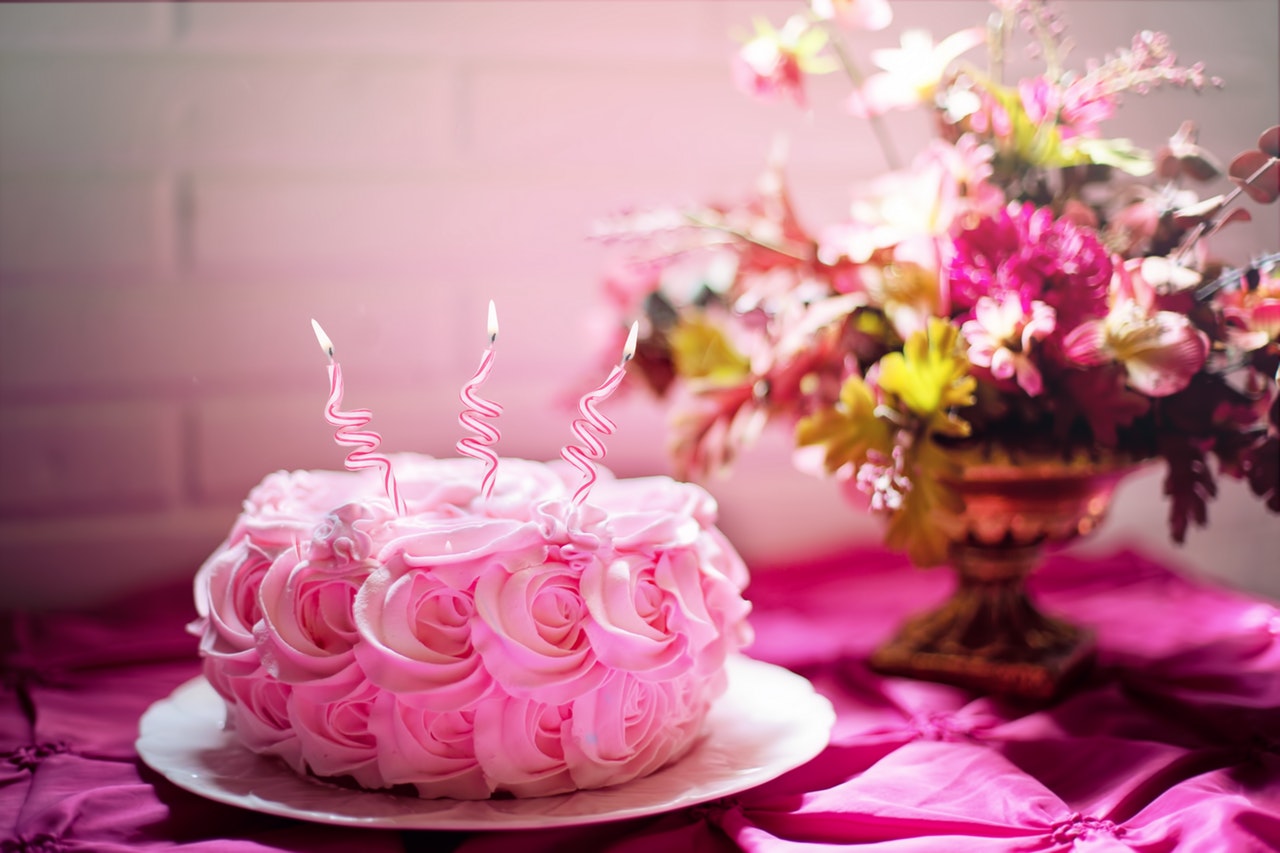 pink smash cake with candles